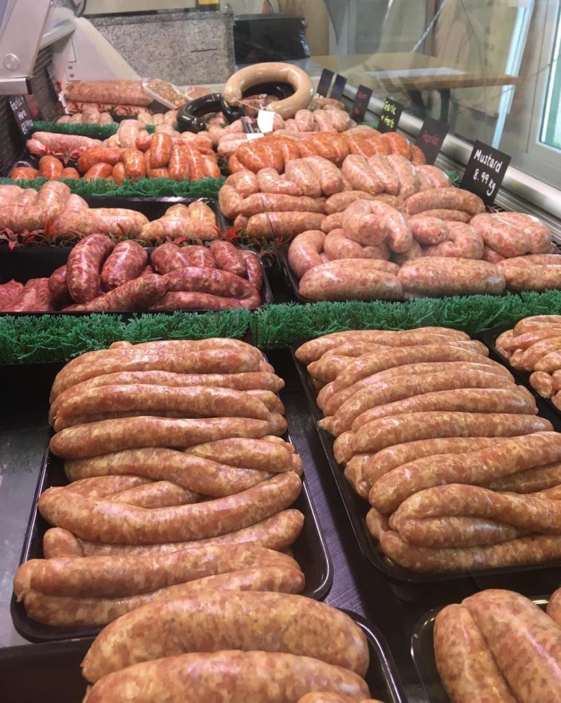 lots of fresh tasty sausages laid out on our traditional butcher counter  